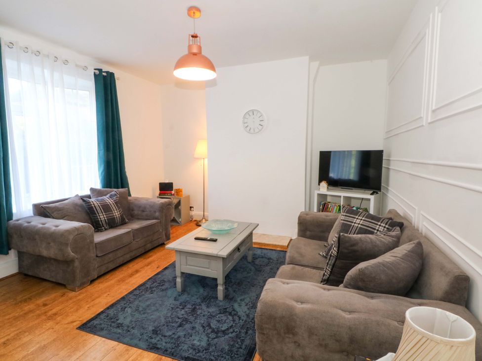 A living room with a sofa and coffee table at Ash House
