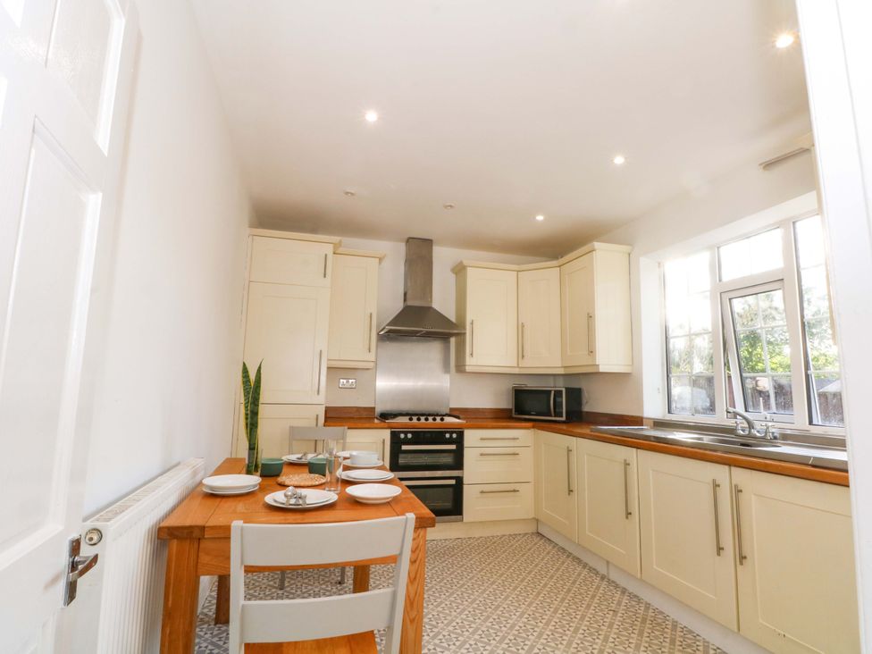 A kitchen with a table and chairs at Ash House
