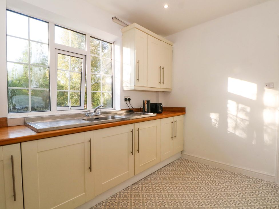 A kitchen with a sink and cabinets at Ash House