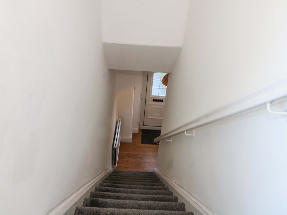 A staircase with a front door visible at Ash House 