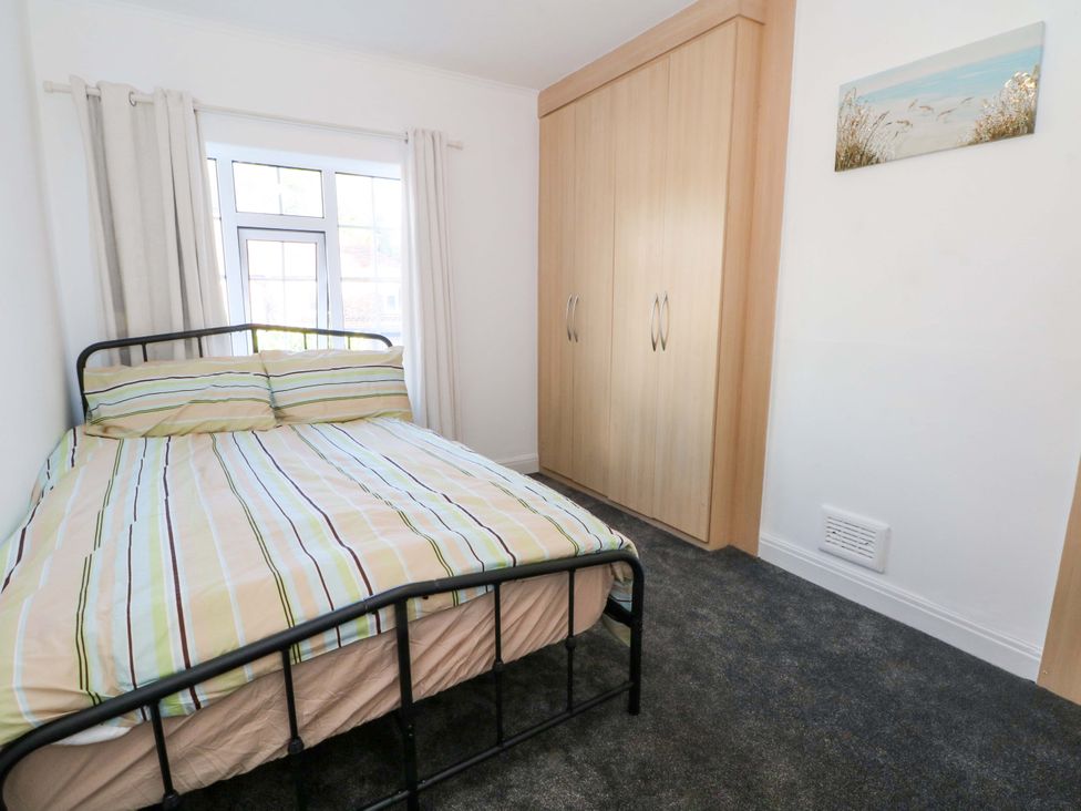 A bedroom with a bed and wardrobe at Ash House
