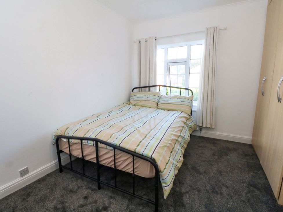 A bedroom with a bed and wardrobe at Ash House