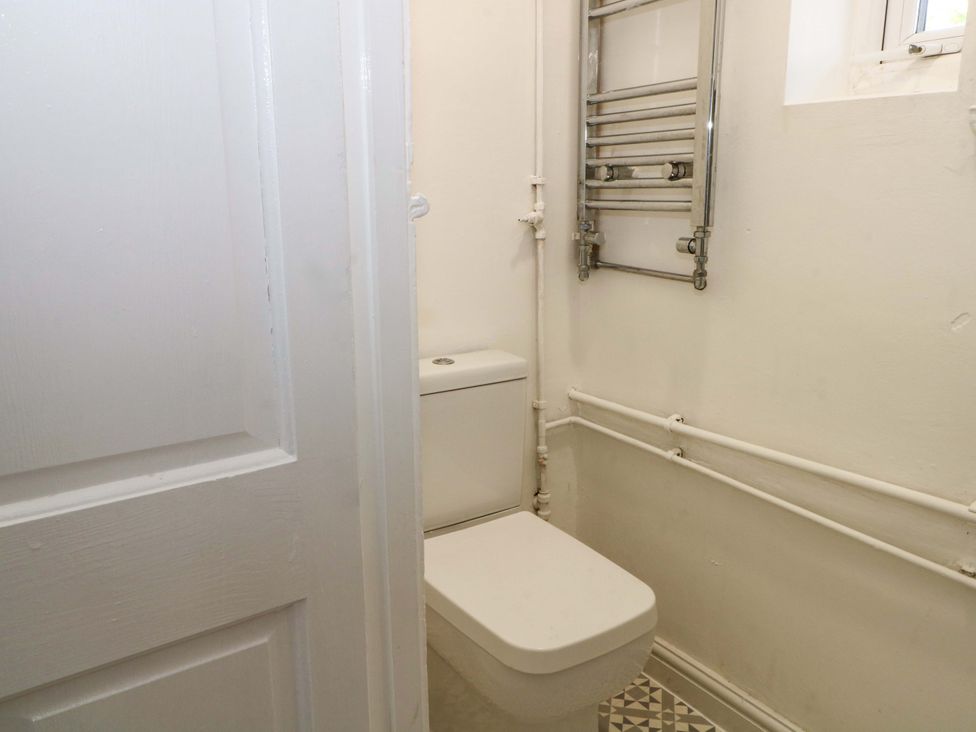 A bathroom with a toilet and radiator at Ash House