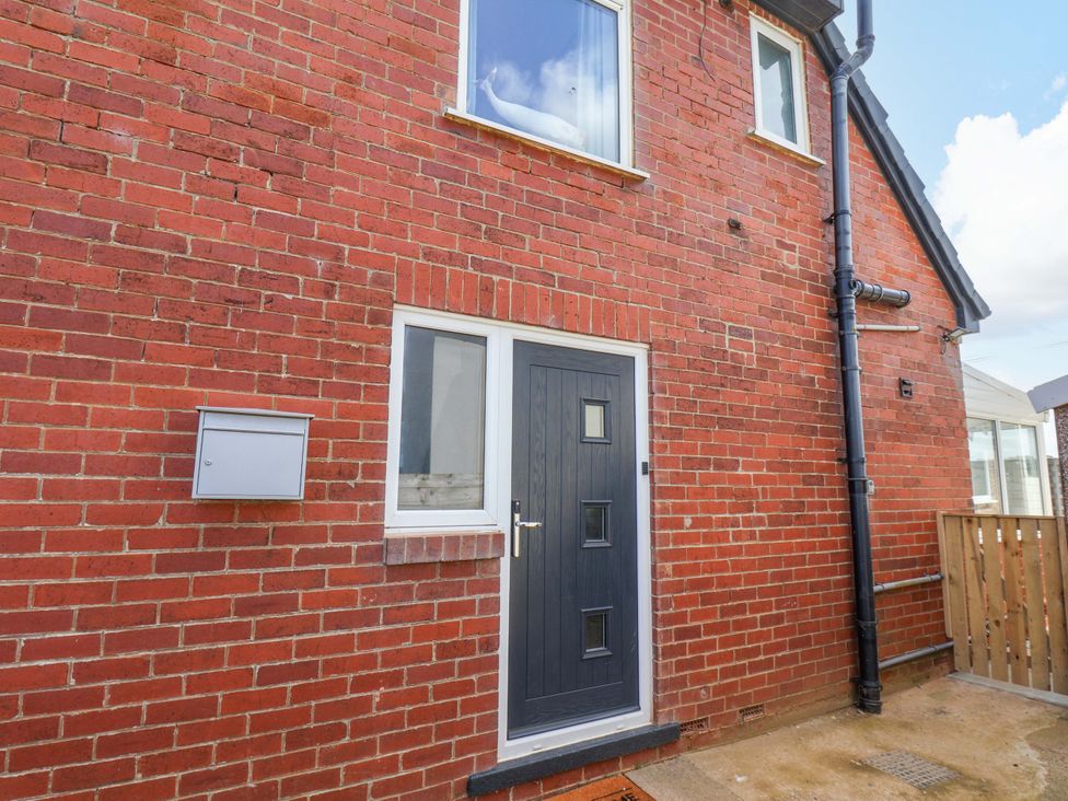 A door and window on a brick wall at Floraville