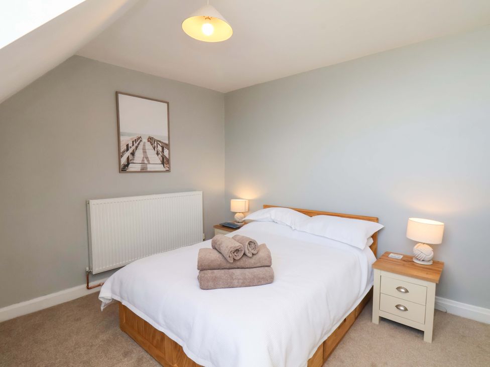 A bedroom with a bed and nightstand at Floraville