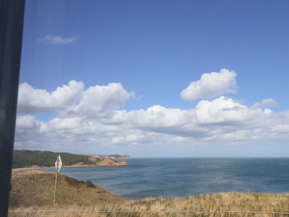 A view of the sea and hills under a cloudy sky at Floraville