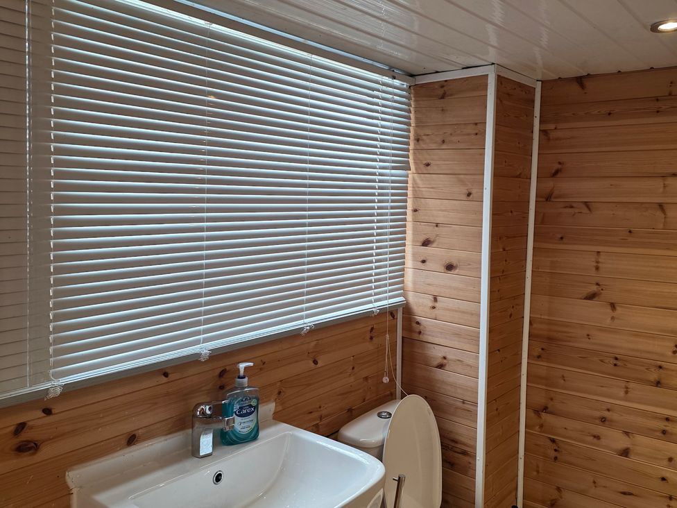 A bathroom with a sink and toilet at Floraville Cayton Bay