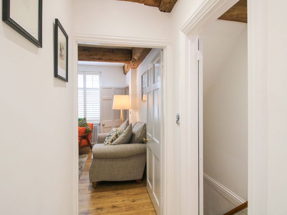 A hallway with a chair and lamp at Raven Lane Retreat in Ludlow