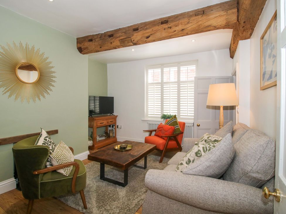 A living room with a sofa, armchair, and coffee table at Raven Lane Retreat in Ludlow
