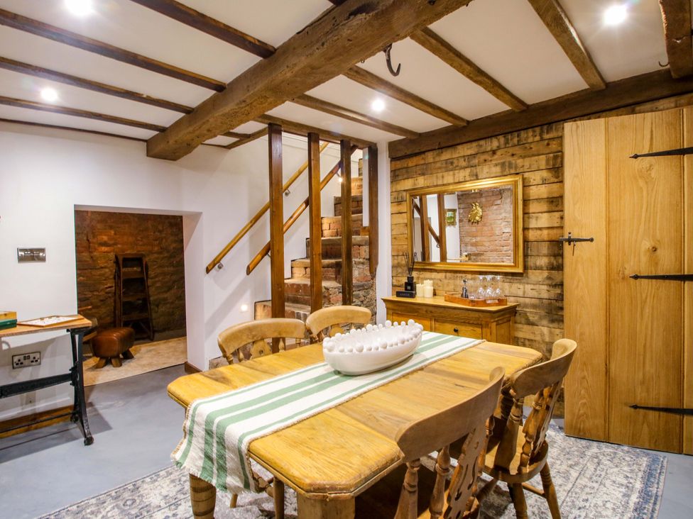 A dining room with a table and chairs at Raven Lane Retreat in Ludlow