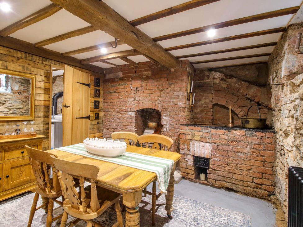 A dining room with a table and chairs at Raven Lane Retreat in Ludlow