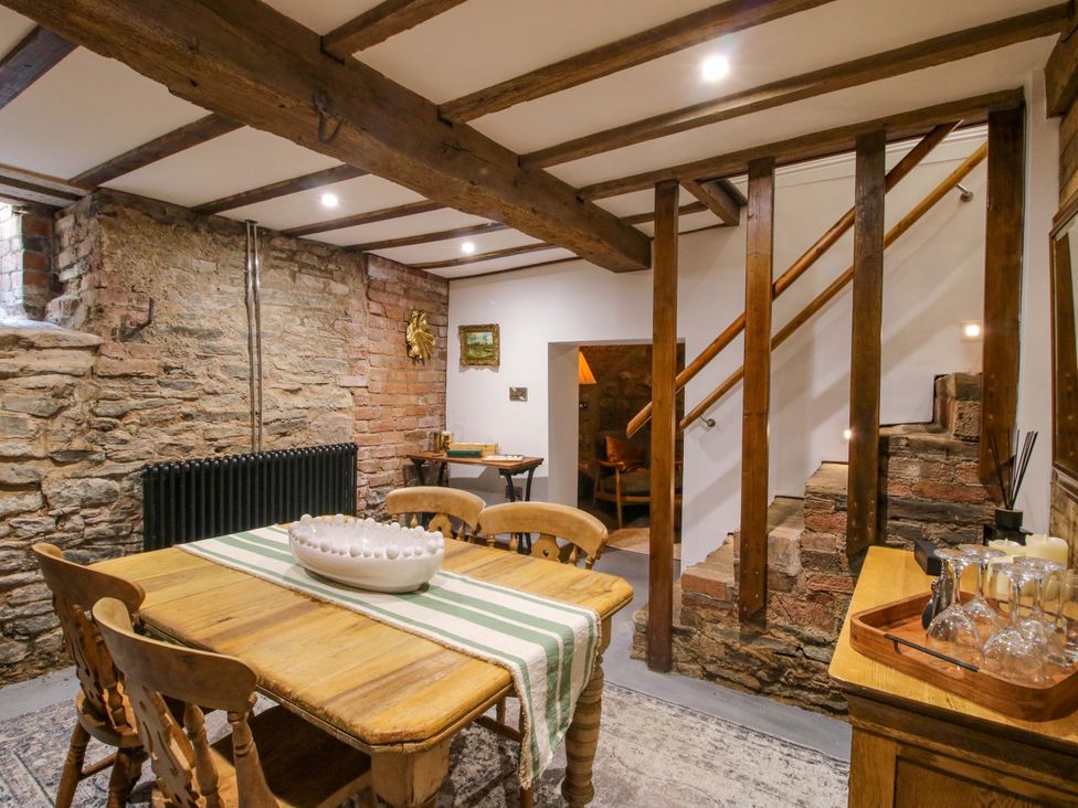 A dining room with a table and chairs at Raven Lane Retreat in Ludlow