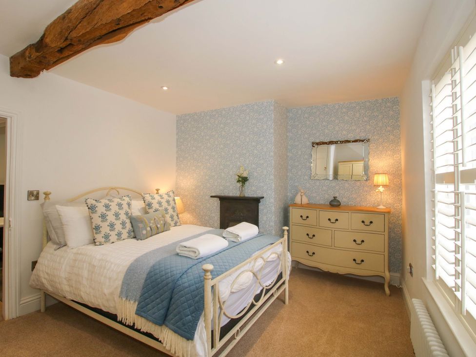 A bedroom with a bed and a dressing table at Raven Lane Retreat in Ludlow