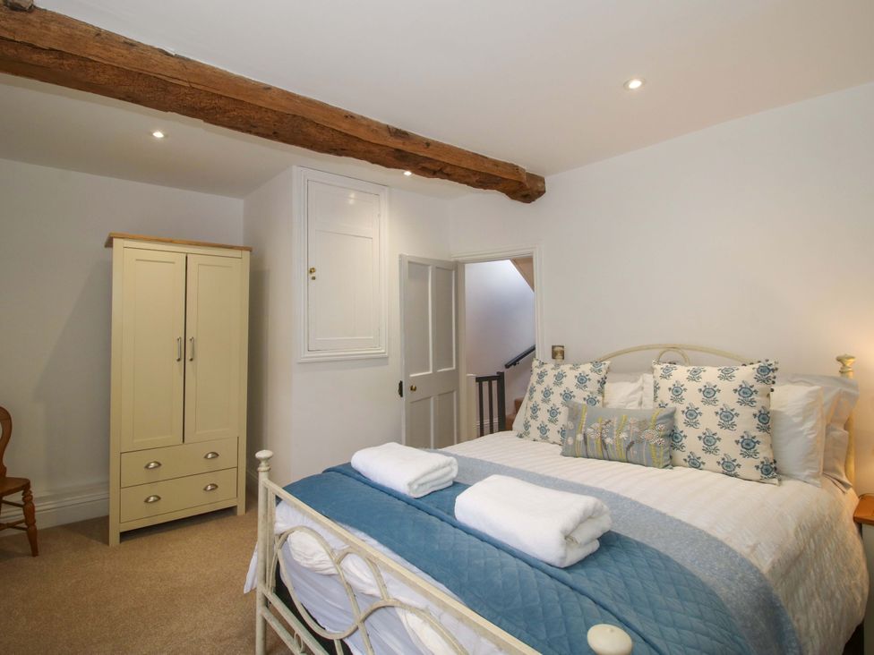 A bedroom with a bed and wardrobe at Raven Lane Retreat in Ludlow
