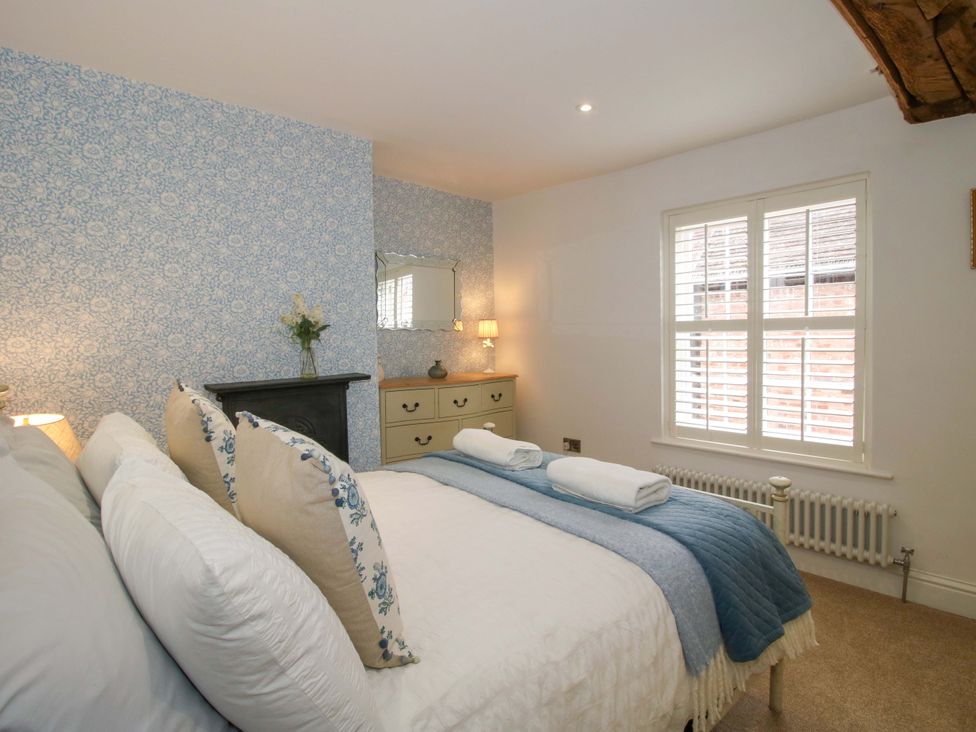 A bedroom with a bed and dresser at Raven Lane Retreat in Ludlow