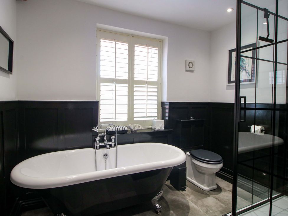 A bathroom with a bathtub and shower at Raven Lane Retreat in Ludlow
