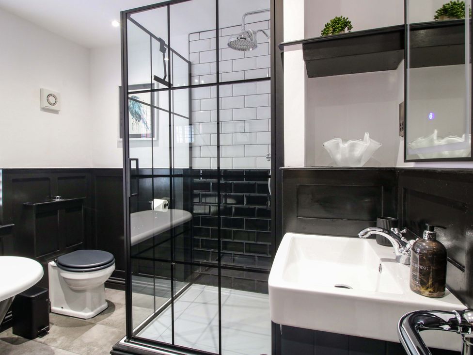 A bathroom with a shower, bathtub and sink at Raven Lane Retreat Ludlow