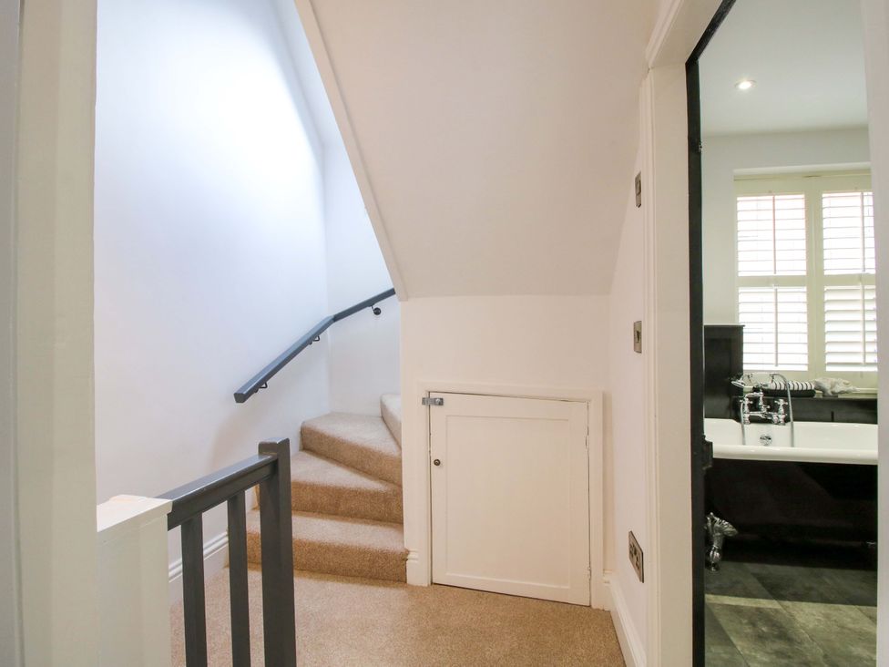 A hallway with stairs leading to a bathroom at Raven Lane Retreat in Ludlow