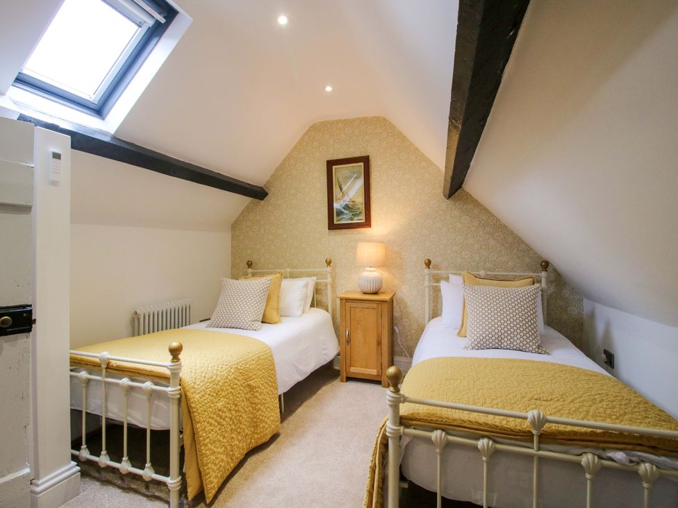 A bedroom with two beds and a lamp at Raven Lane Retreat in Ludlow