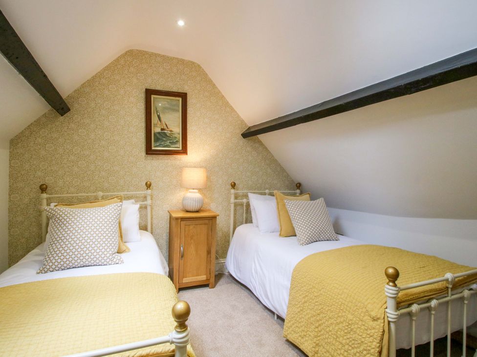 A bedroom with two metal beds and a lamp at Raven Lane Retreat in Ludlow