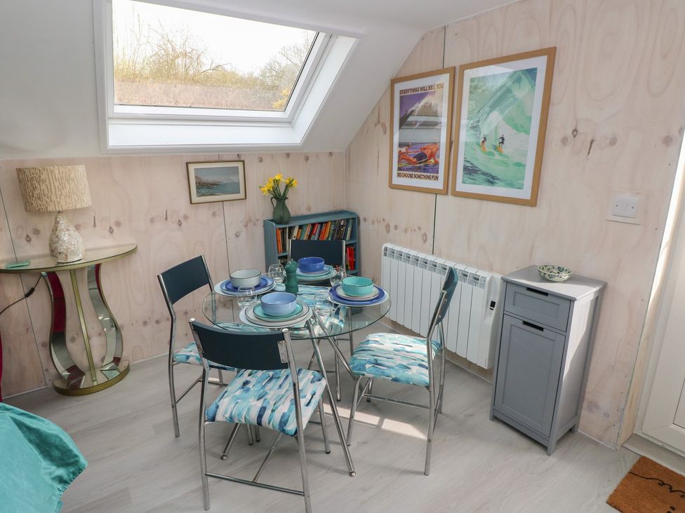A dining room with a glass table and four chairs at Over the way Cosheston near Pembroke