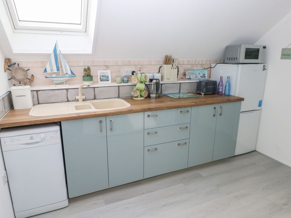 A kitchen with sink and appliances at Over the way Cosheston near Pembroke