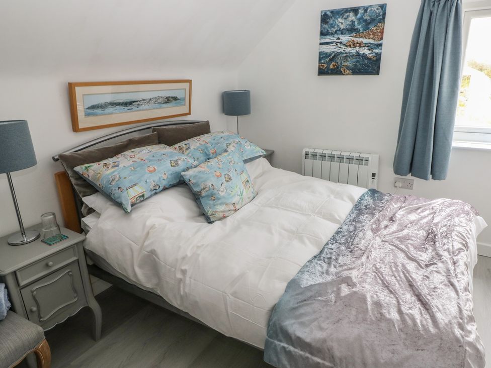 A bedroom with a double bed and bedside table at Over the way Cosheston near Pembroke