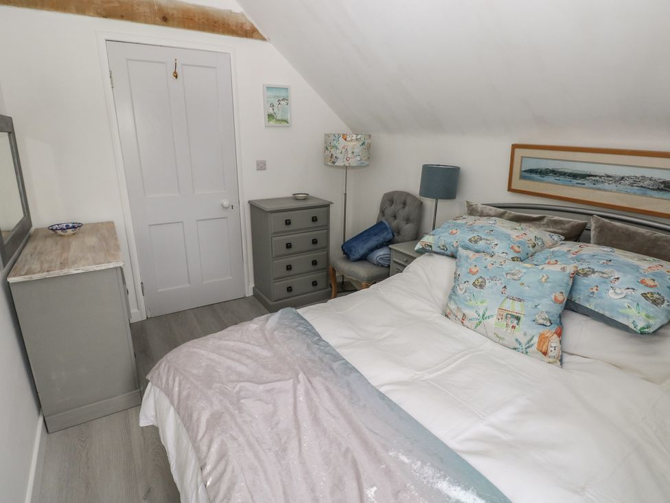 A bedroom with a bed and bedside furniture at Over the way Cosheston near Pembroke