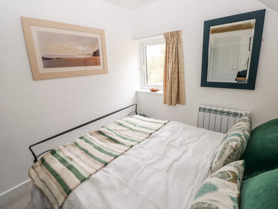 A bedroom with a bed and window at Over the way Cosheston near Pembroke