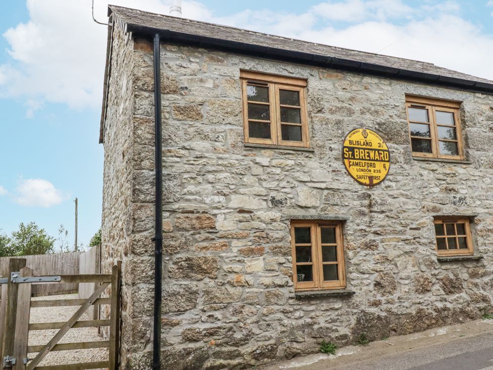 A stone building with windows and a sign at The Old Dairy in 