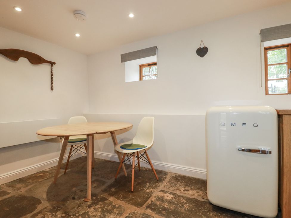 A kitchen with a table and chairs at The Old Dairy in 