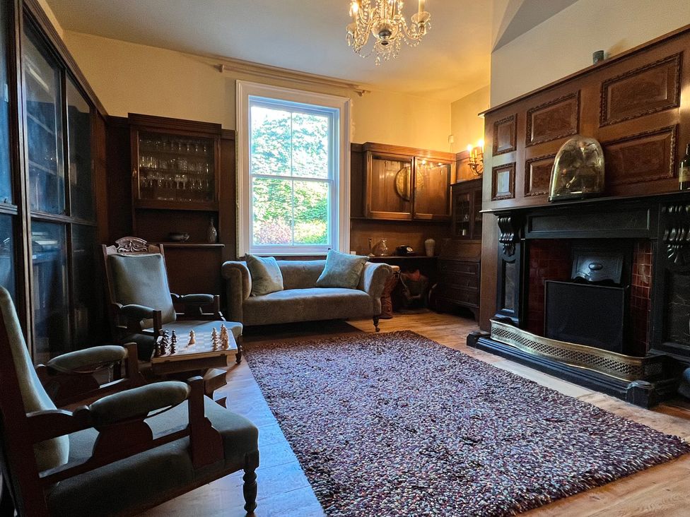 A living room with a sofa, chairs, and a chess board at Your Country House in Reading
