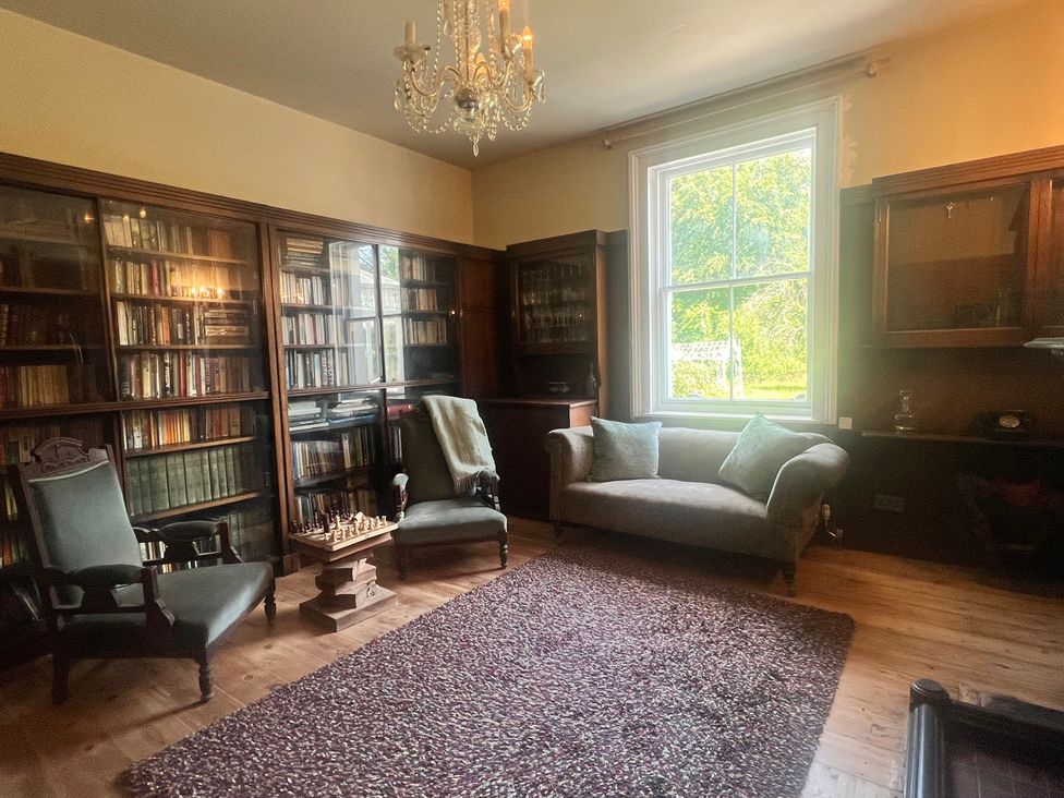A library with bookshelves and a chess set at Your Country House in Reading
