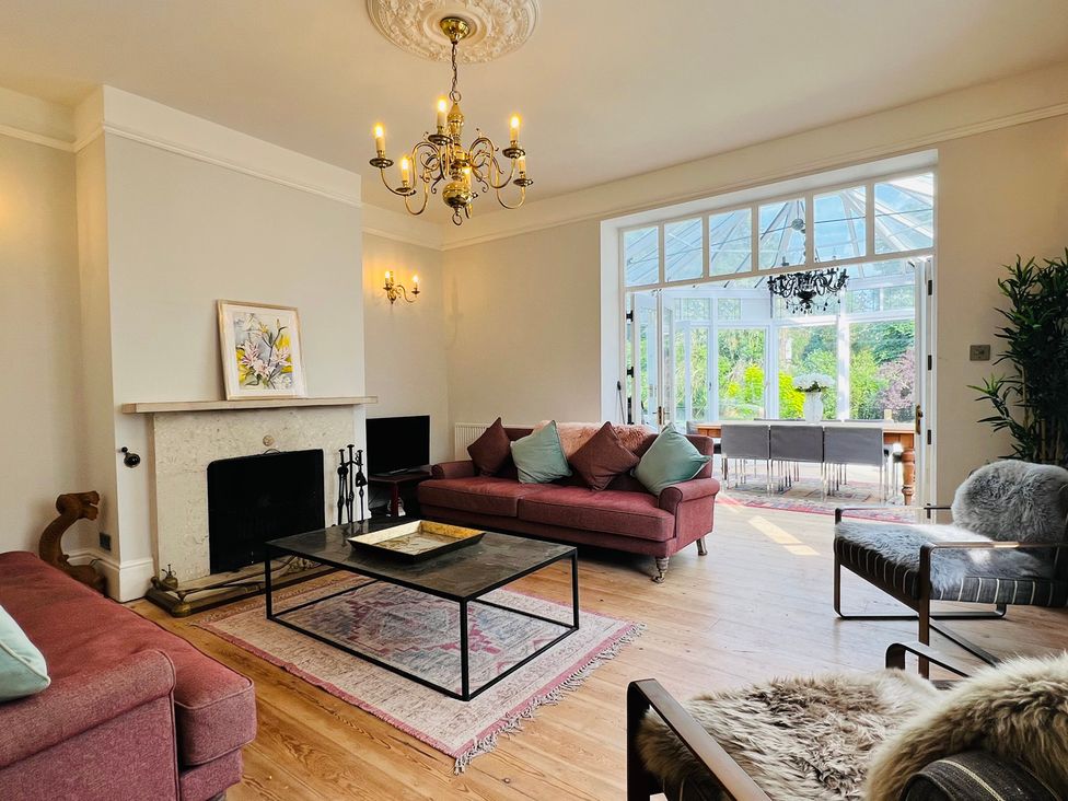 A living room with a fireplace and sofa at Your Country House in Reading