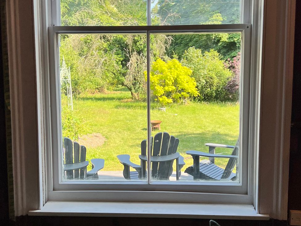 A view from a window of chairs in a garden at Your Country House in Reading
