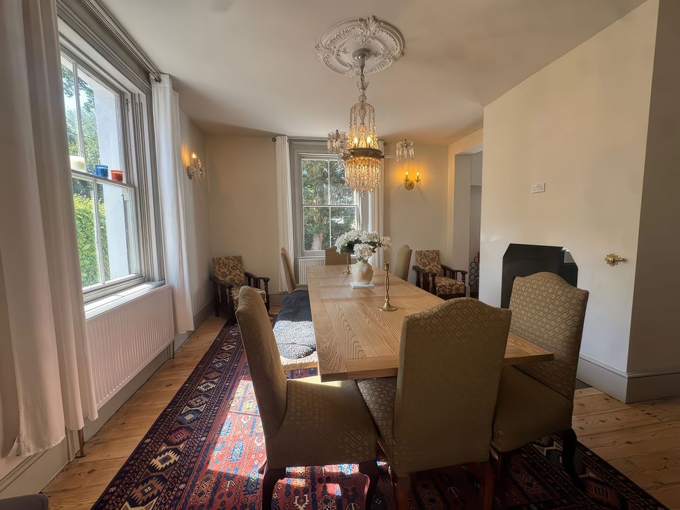 A dining room with a table and chairs at Your Country House in Reading