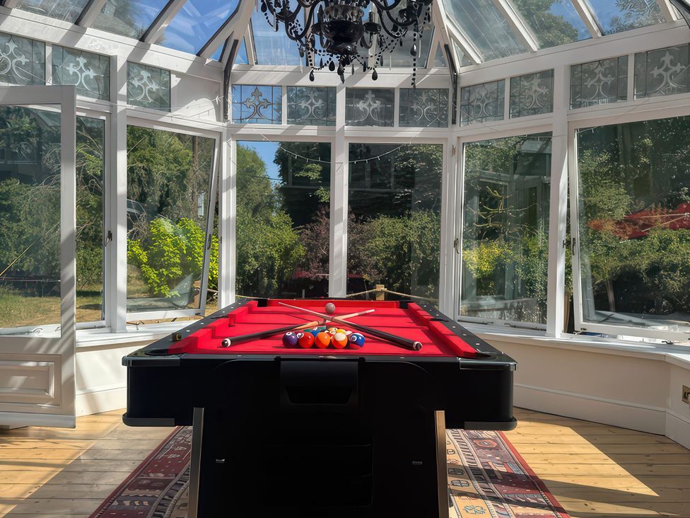 A pool table with balls in a conservatory at Your Country House in Reading