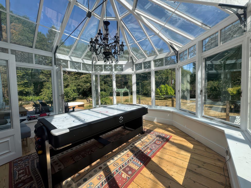 A conservatory with an air hockey table at Your Country House in Reading