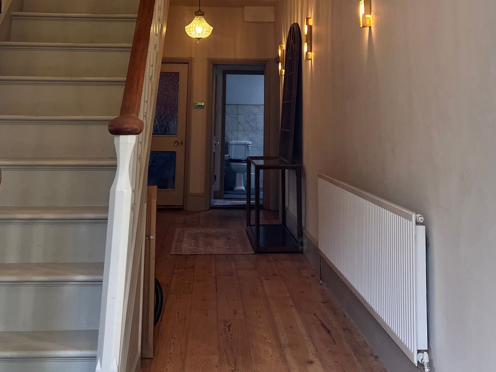 A hallway with a staircase and a door to a bathroom at Your Country House in Reading
