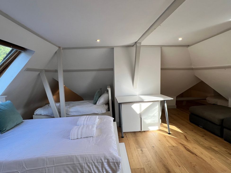 A bedroom with two beds and a desk at Your Country House in Reading