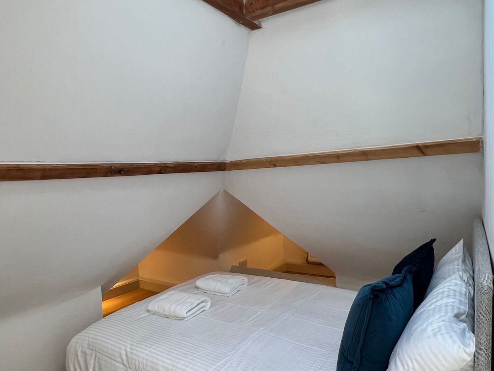 A bedroom with a bed and towels at Your Country House in Reading