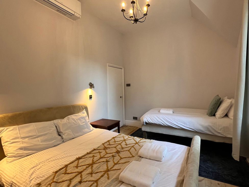 A bedroom with a bed and a single bed at Your Country House in Reading