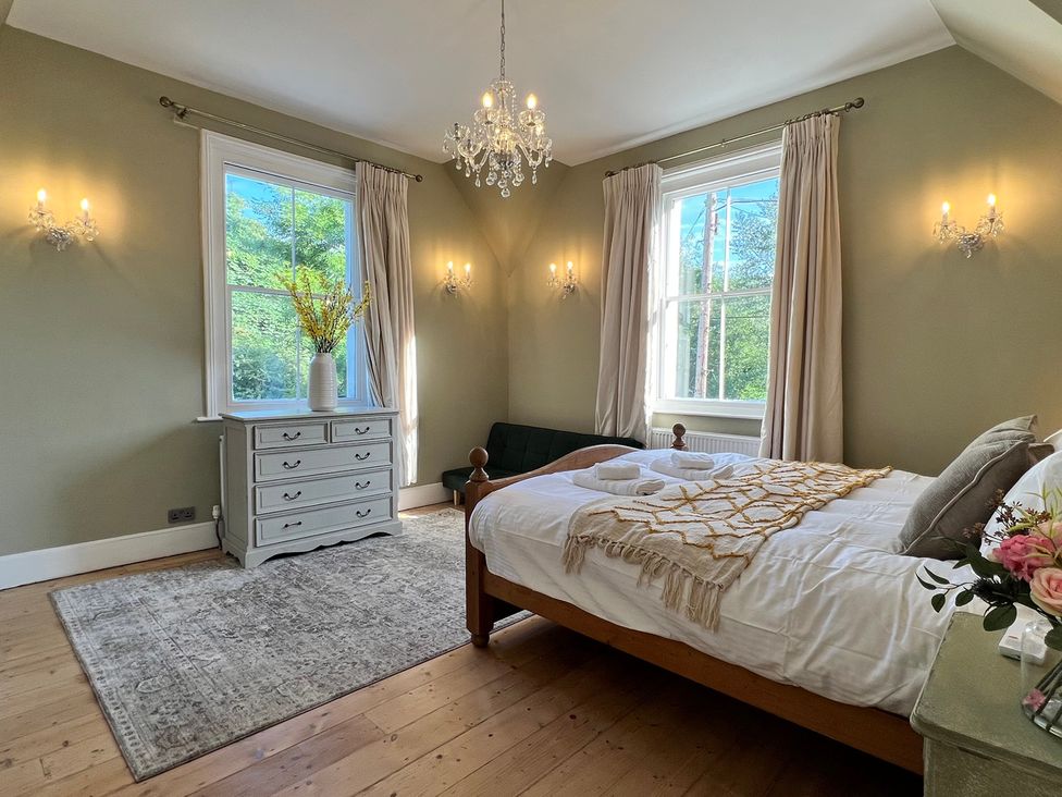 A bedroom with a bed and dresser at Your Country House in Reading