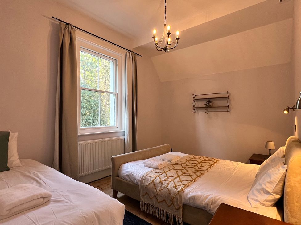 A bedroom with two beds and a window at Your Country House in Reading