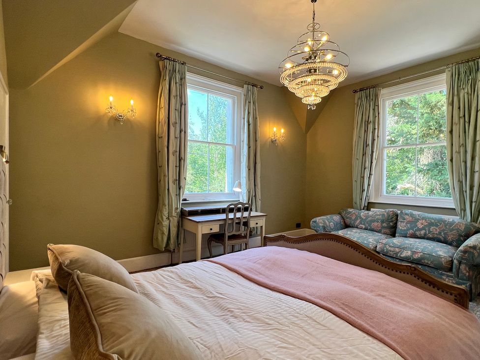 A bedroom with a bed and a desk at Your Country House in Reading