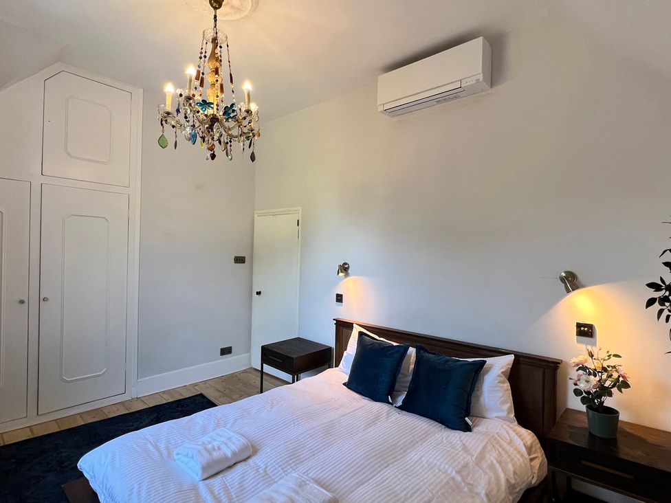A bedroom with a bed and wardrobe at Your Country House, Reading