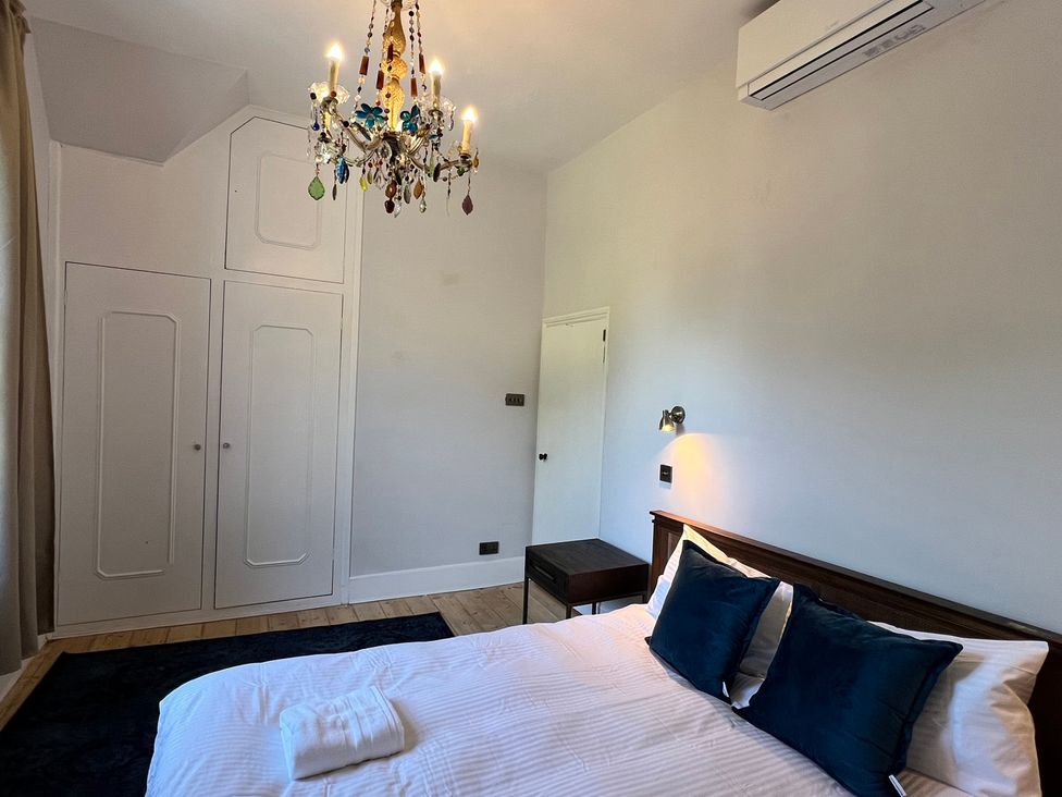 A bedroom with a bed and wardrobe at Your Country House in Reading
