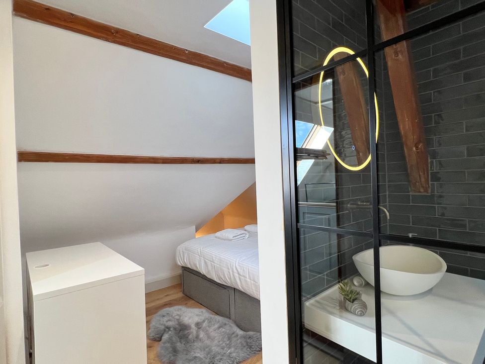 A bedroom with a bed and a bathroom view at Your Country House in Reading