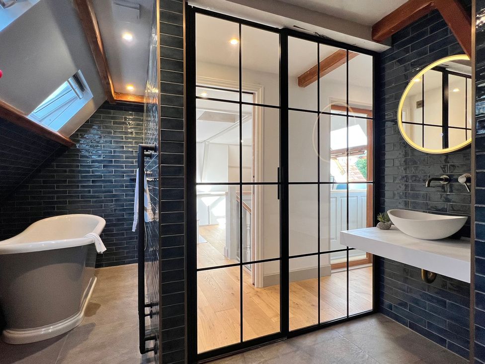 A bathroom with a bathtub and sink at Your Country House in Reading
