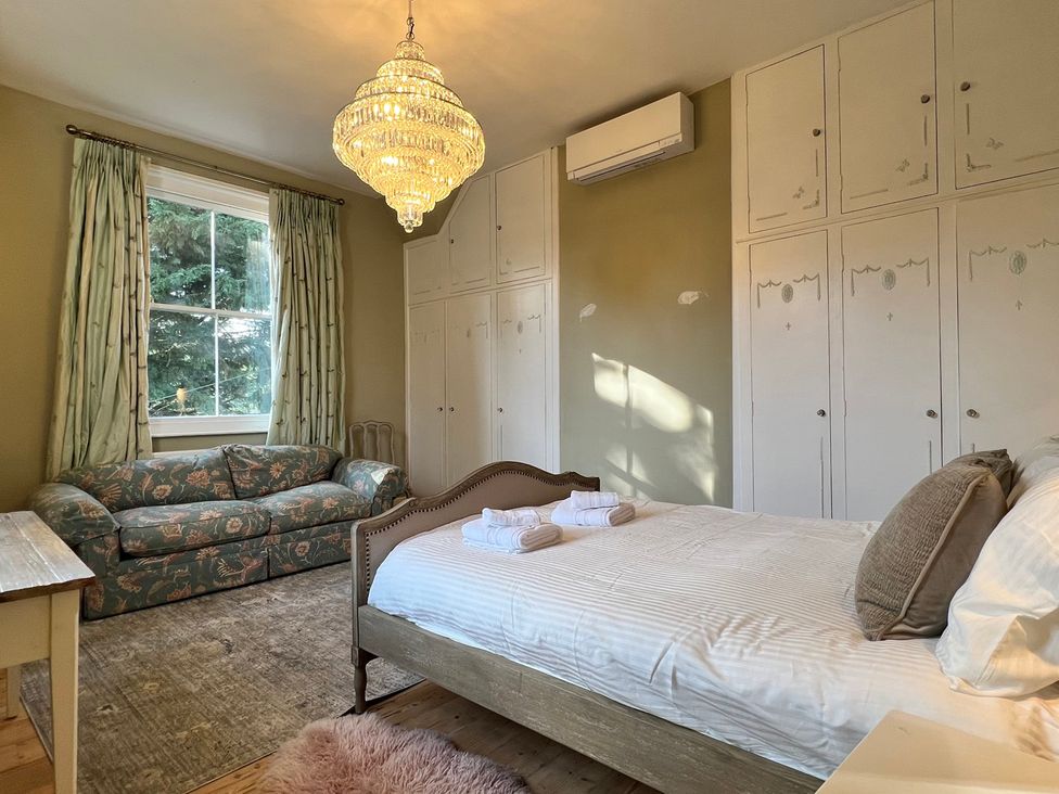 A bedroom with a bed and a sofa at Your Country House in Reading